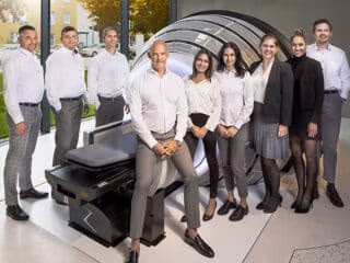 Staff at European Radiosurgery Center stand in group near ZAP-X