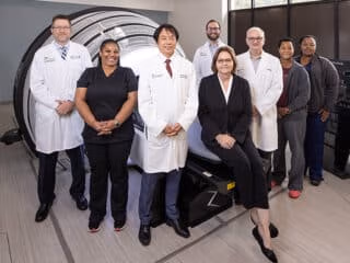 Staff at MedStar Georgetown Cancer Institute at Southern Maryland Hospital Center stand in group near ZAP-X
